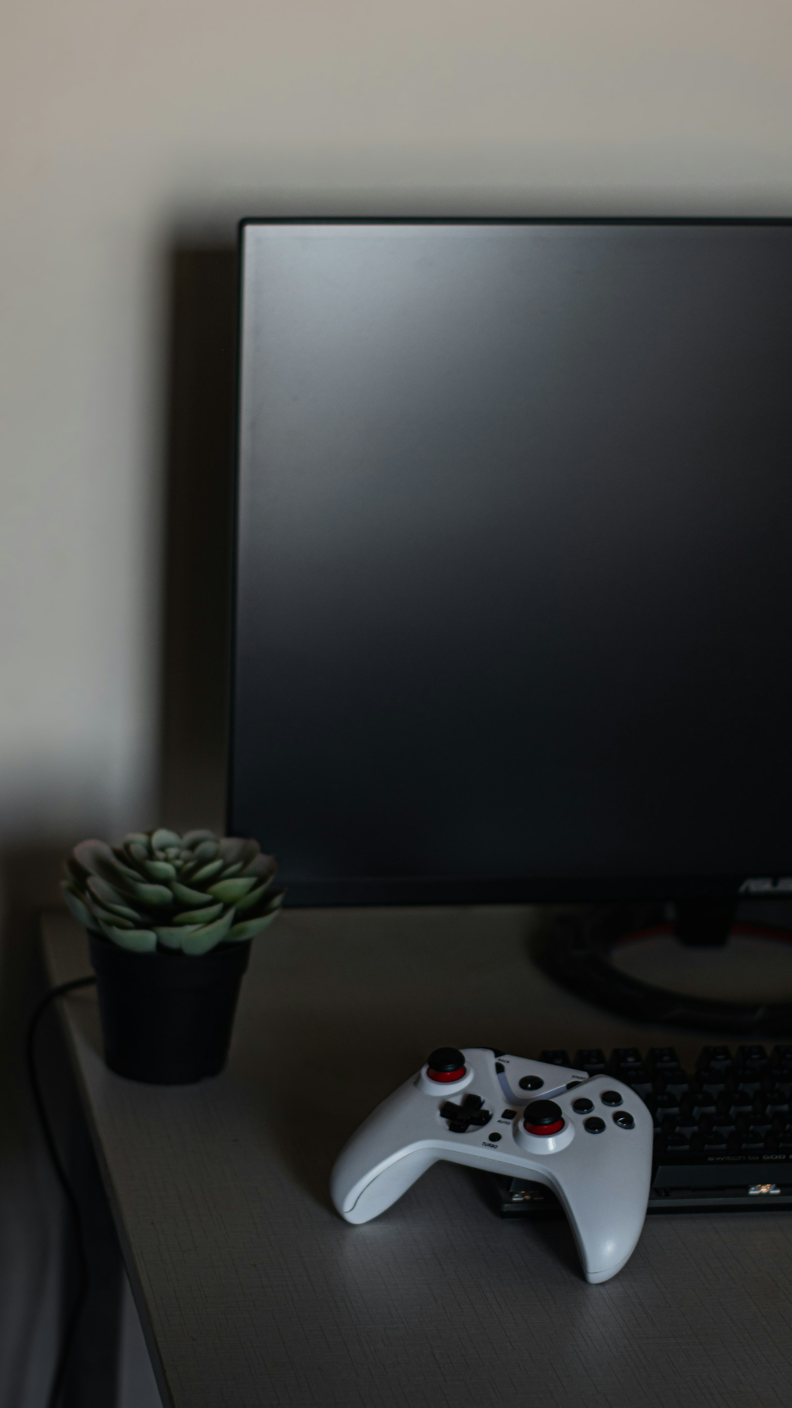 Gaming desk with controller and monitor lit like a route-planning station